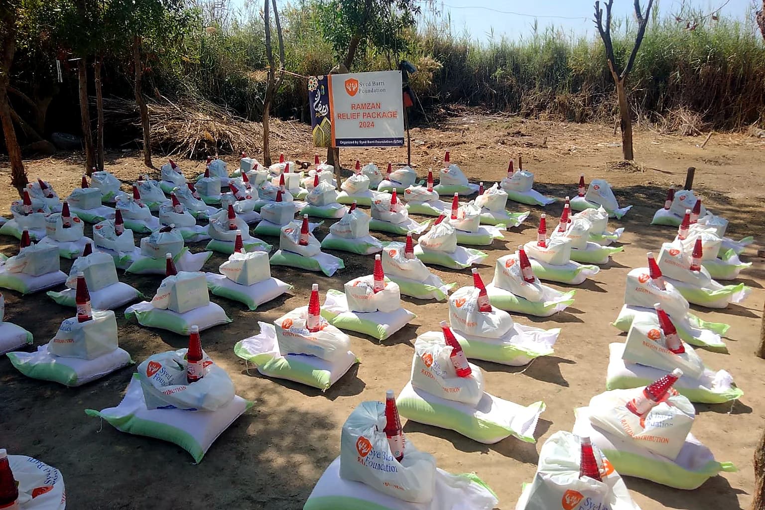 Family relief packages prepared in an outdoor distribution area