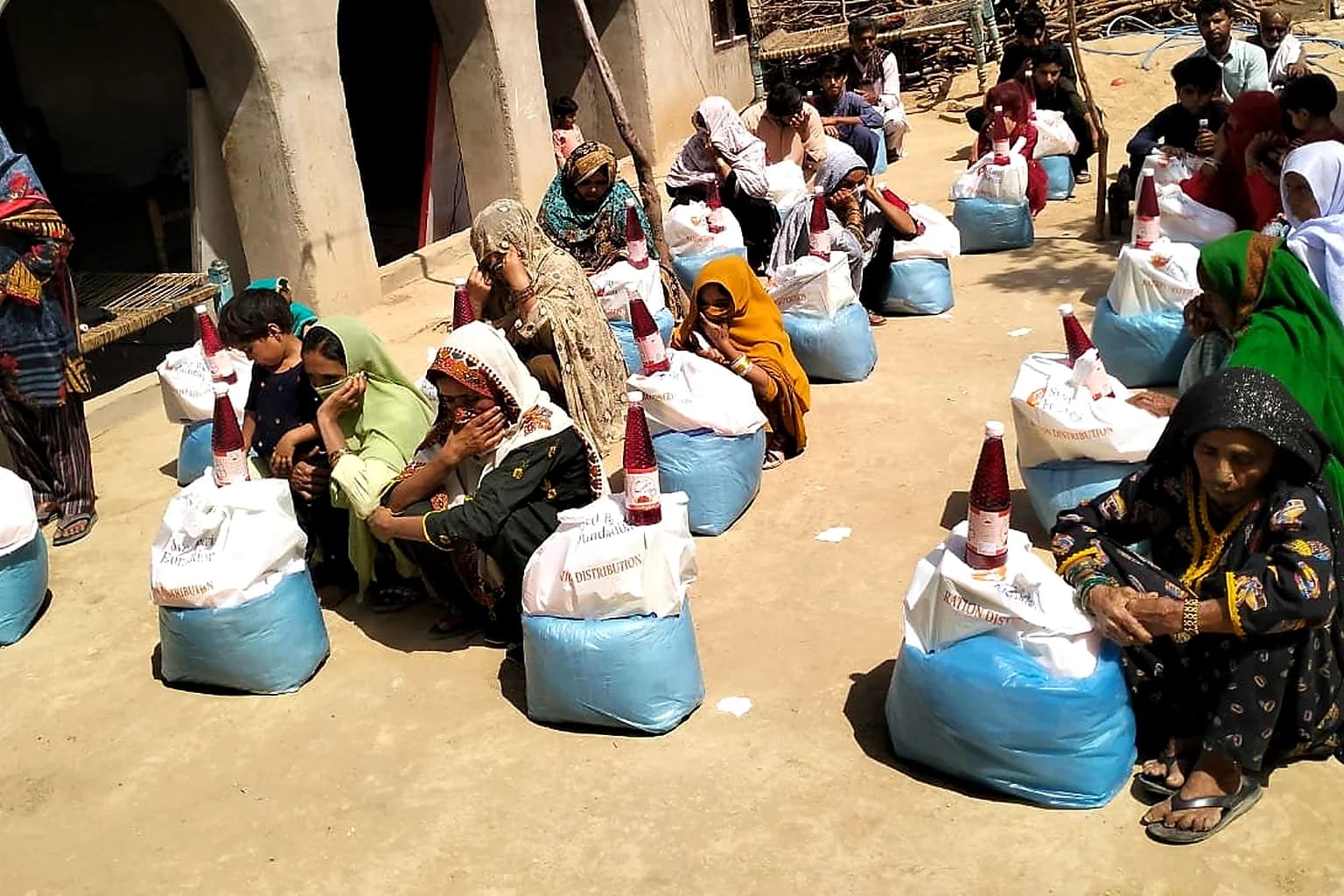 Community members receiving food packs from foundation efforts